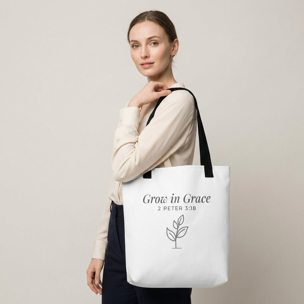 Lifestyle photo of a model holding a white tote bag with black handles featuring “Grow in Grace,” “2 Peter 3:18,” and a plant design in dark gray.