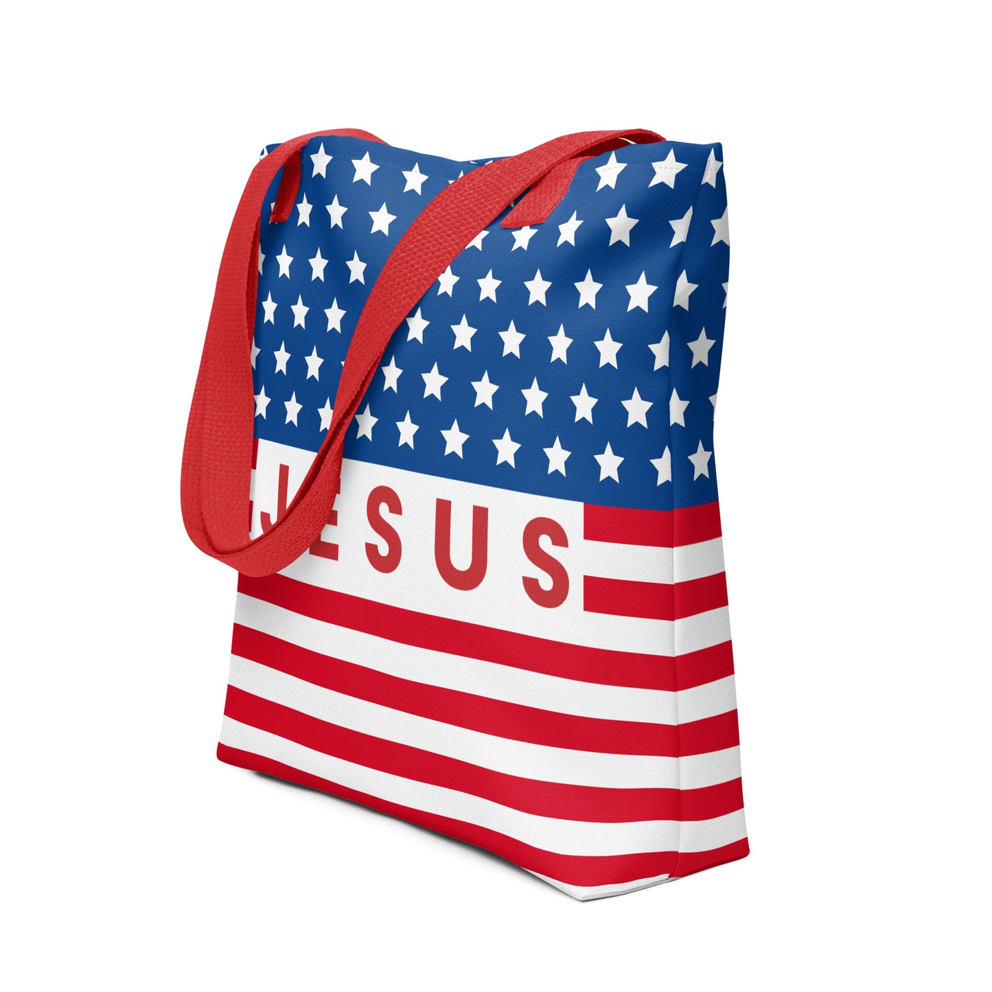 Angled view of a Christian American flag tote bag featuring red handles, white stars on blue, red stripes, and bold “Jesus” lettering.