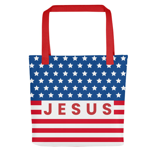 Front view of a patriotic Christian tote bag with red handles, blue stars, red and white stripes, and “Jesus” text across the center.