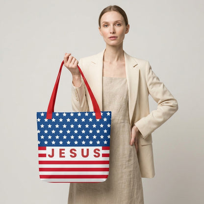 Model carrying a patriotic Christian tote bag with red handles, an American flag-inspired design, and “Jesus” text across the front.
