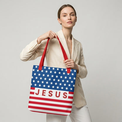 Model carrying a patriotic Christian tote bag with red handles, an American flag-inspired design, and “Jesus” text across the front.
