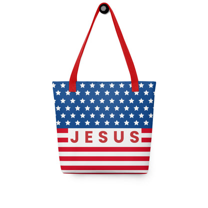Christian patriotic tote bag hanging on a hook, featuring red straps, white stars, red stripes, and a bold “Jesus” design.