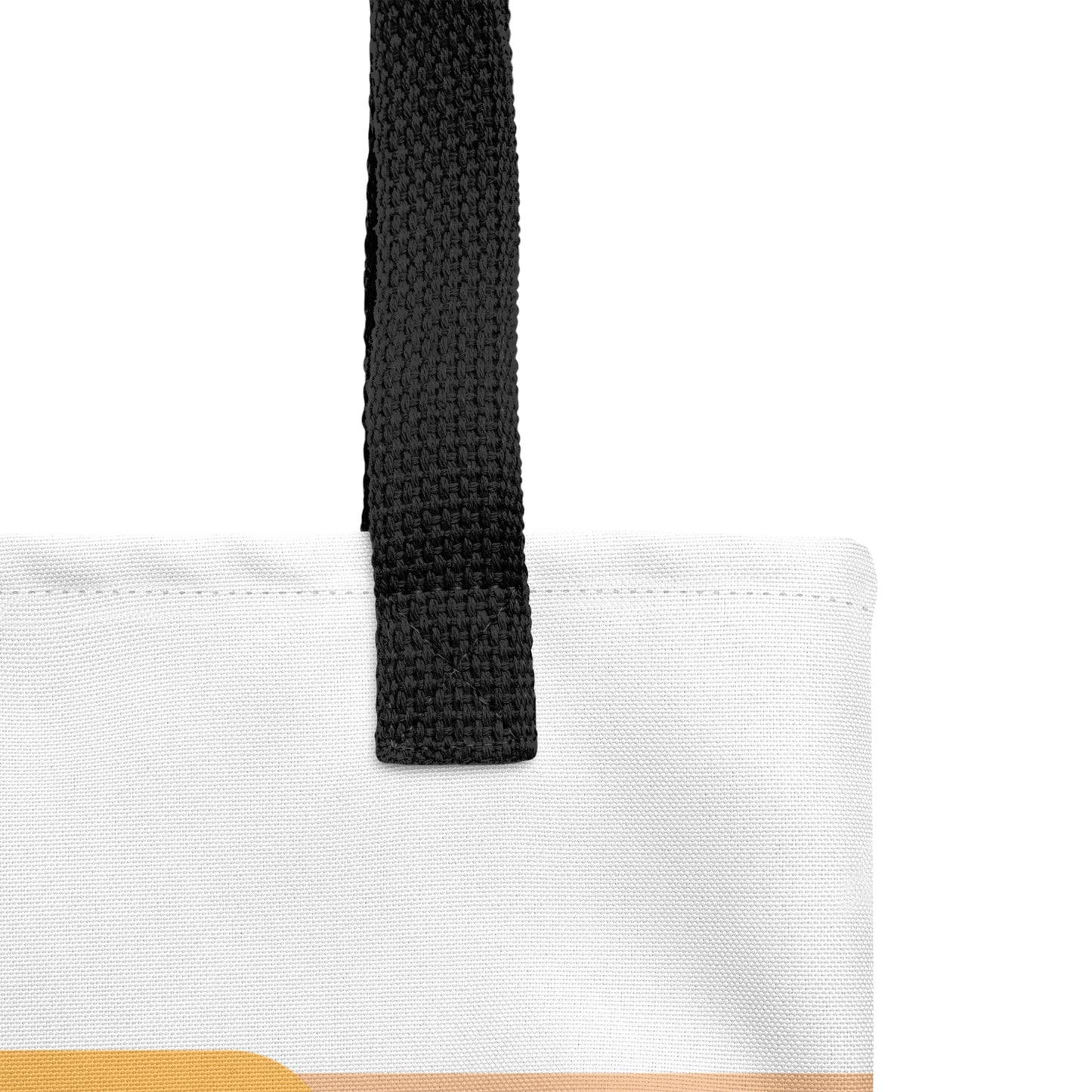 Close-up of the tote bag fabric and stitching with black strap and the edge of the “Jesus and More Jesus” design visible.