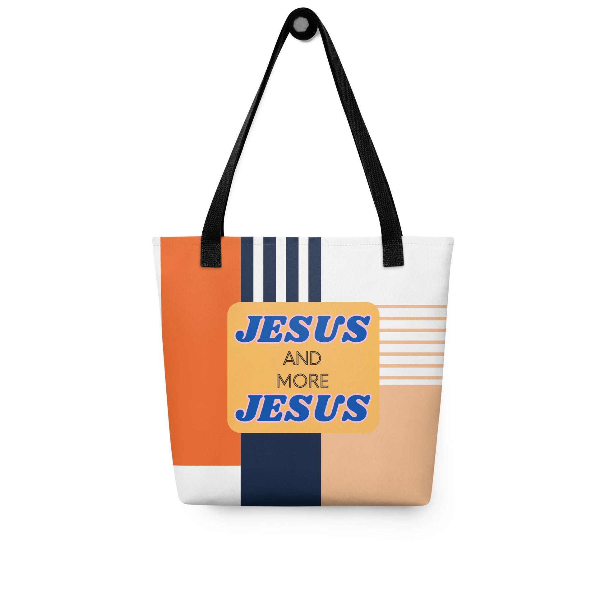 “Jesus and More Jesus” tote bag hanging on a hook, featuring black handles and a bold color-block front graphic.