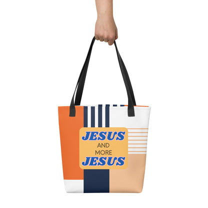 Hand-held “Jesus and More Jesus” tote bag with black straps and a geometric orange, navy, and beige color-block pattern.