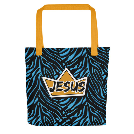 Tote bag with yellow handles and a blue-and-black zebra pattern, featuring a gold crown graphic with “JESUS” in the center.