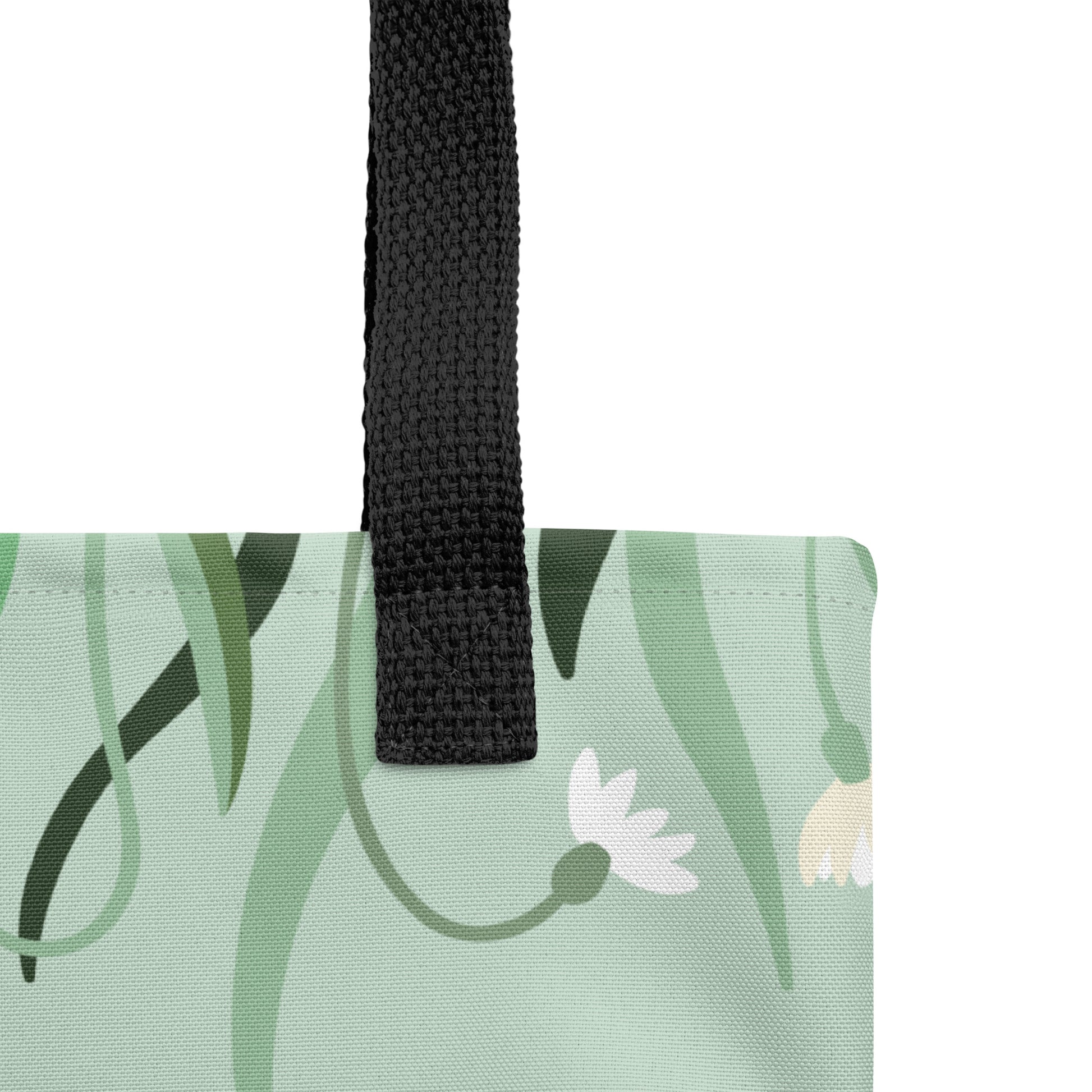 Close-up of the mint floral tote fabric and black strap, highlighting the stitching, textured canvas, and flower pattern.