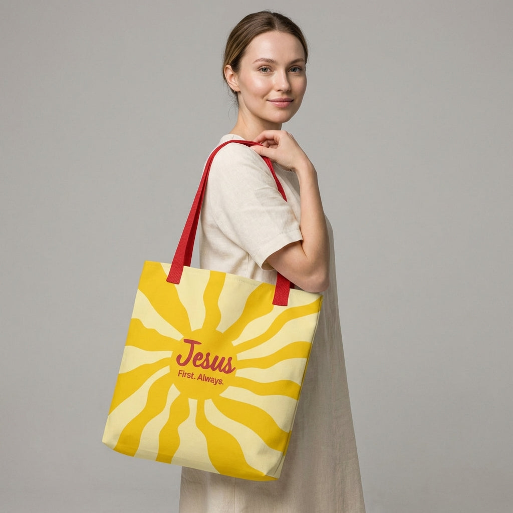 Lifestyle photo of a person carrying the red-strap “Jesus First. Always.” yellow sunburst tote bag.
