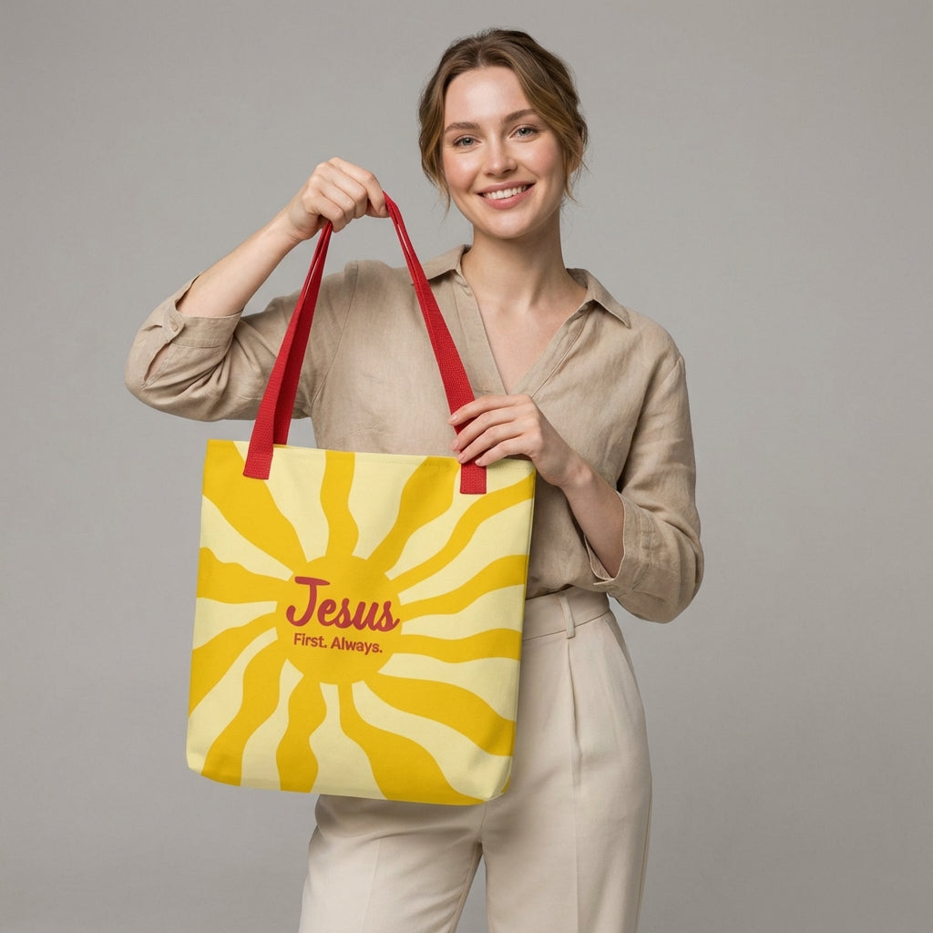Lifestyle photo of a person carrying the red-strap “Jesus First. Always.” yellow sunburst tote bag.