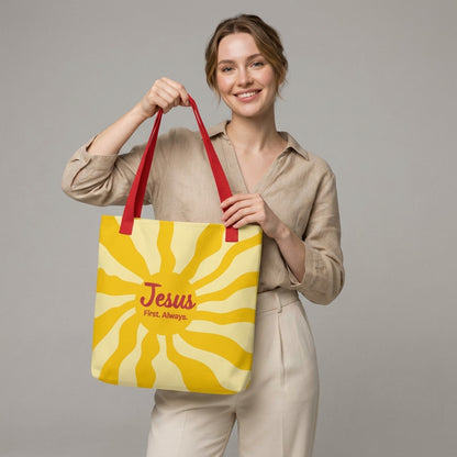 Lifestyle photo of a person carrying the red-strap “Jesus First. Always.” yellow sunburst tote bag.