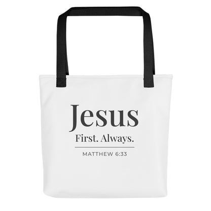 White tote bag with black handles featuring “Jesus First. Always.” and “Matthew 6:33” in dark gray text.