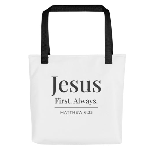 White tote bag with black handles featuring “Jesus First. Always.” and “Matthew 6:33” in dark gray text.