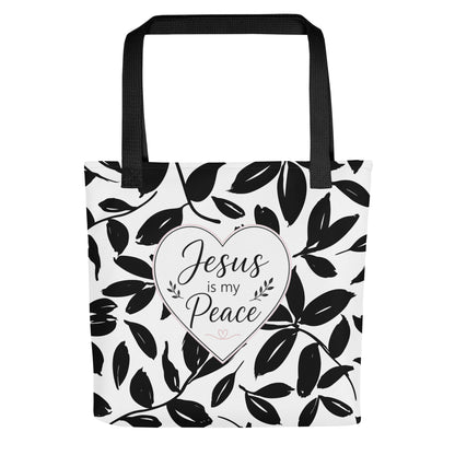 Front view of a black and white Christian tote bag with black handles, leafy pattern, and a heart design that says “Jesus is my Peace.”
