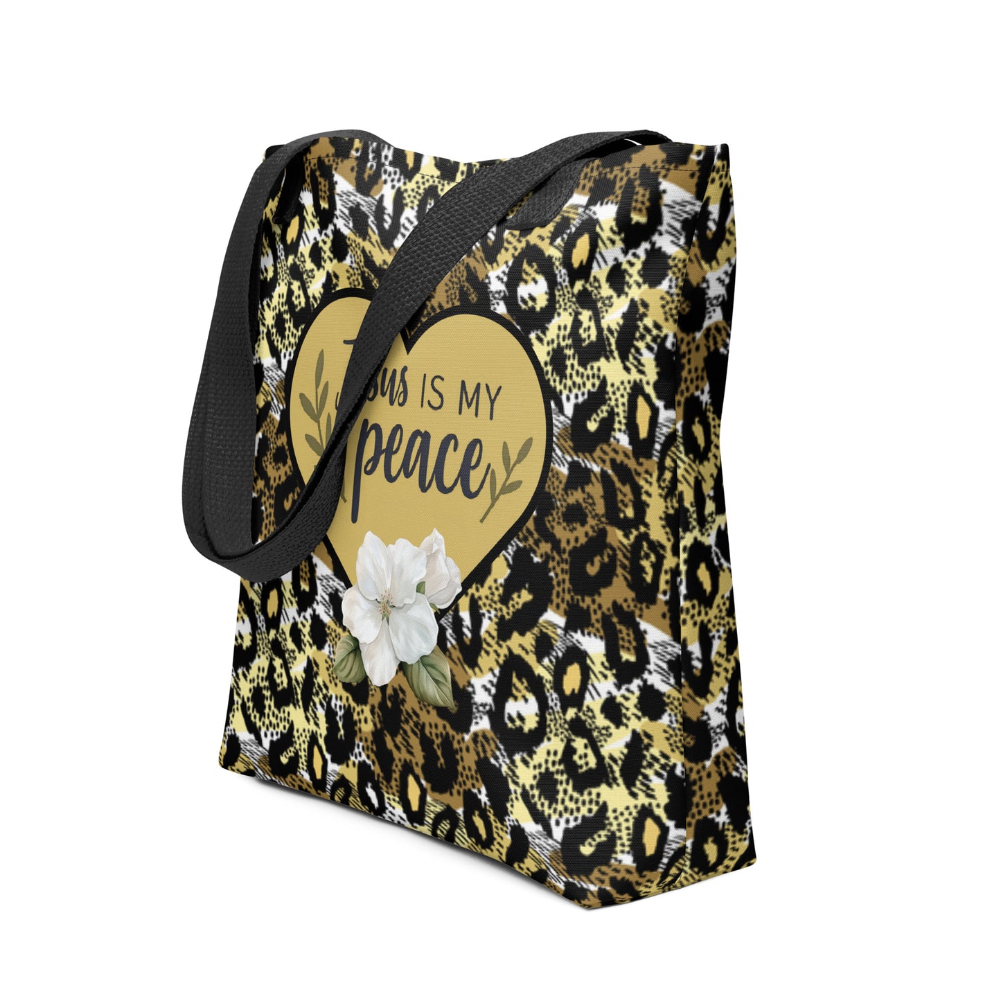 Angled view of the “Jesus is my peace” tote featuring black straps, gold-and-black cheetah pattern, gold heart graphic, and white flower detail.