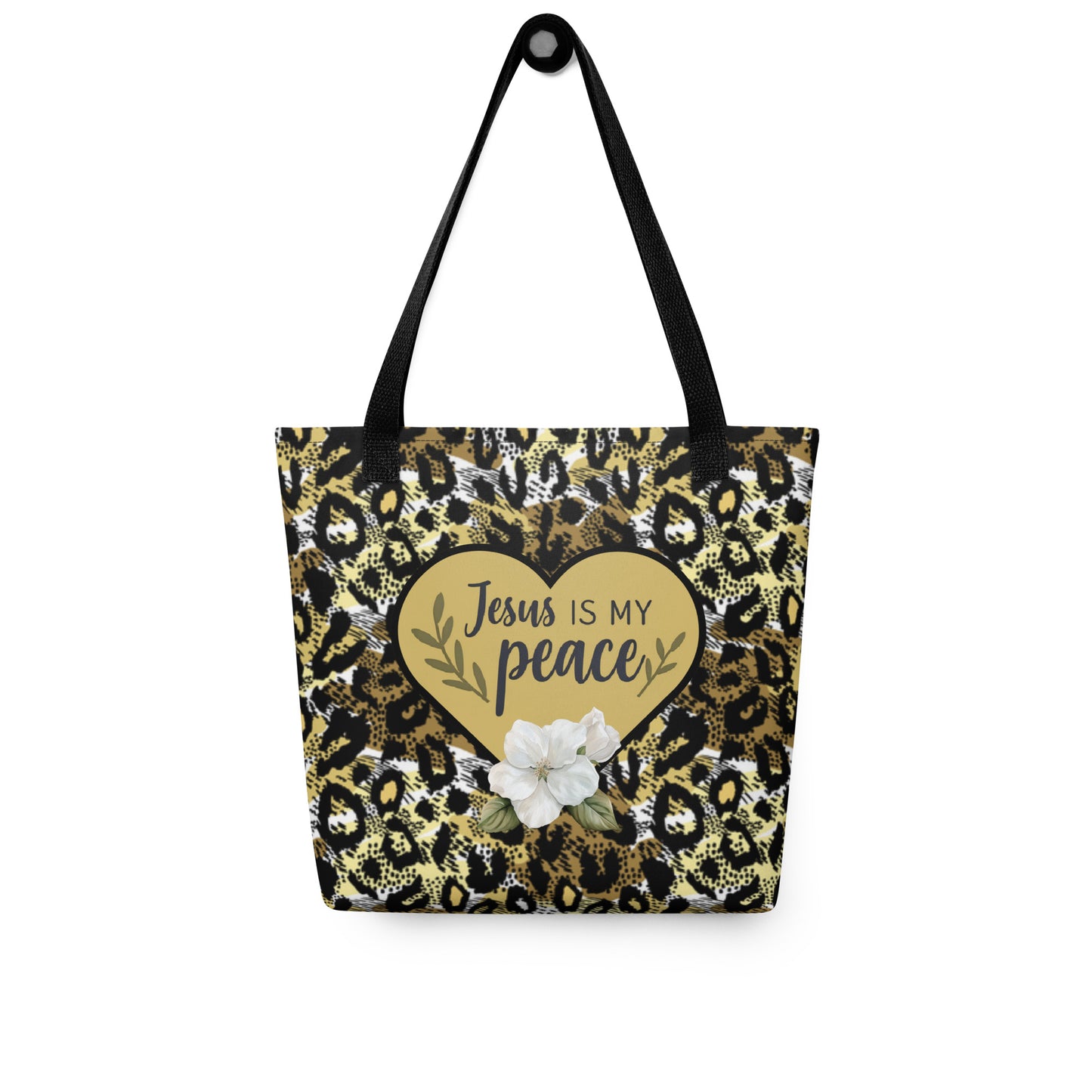 “Jesus is my peace” cheetah print tote hanging on a hook, showing black handles, gold heart design, and white flower on the front.