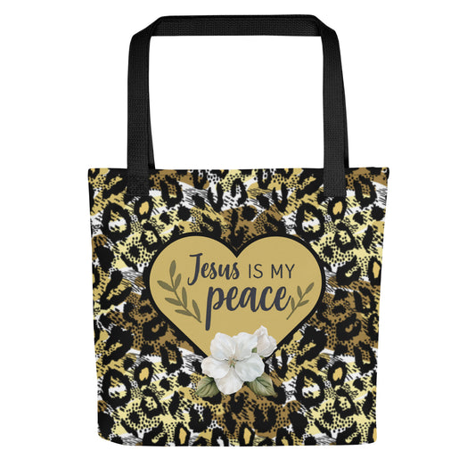 Front view of tote bag with black handles, gold cheetah print, and a gold heart that says “Jesus is my peace” with a white flower accent.