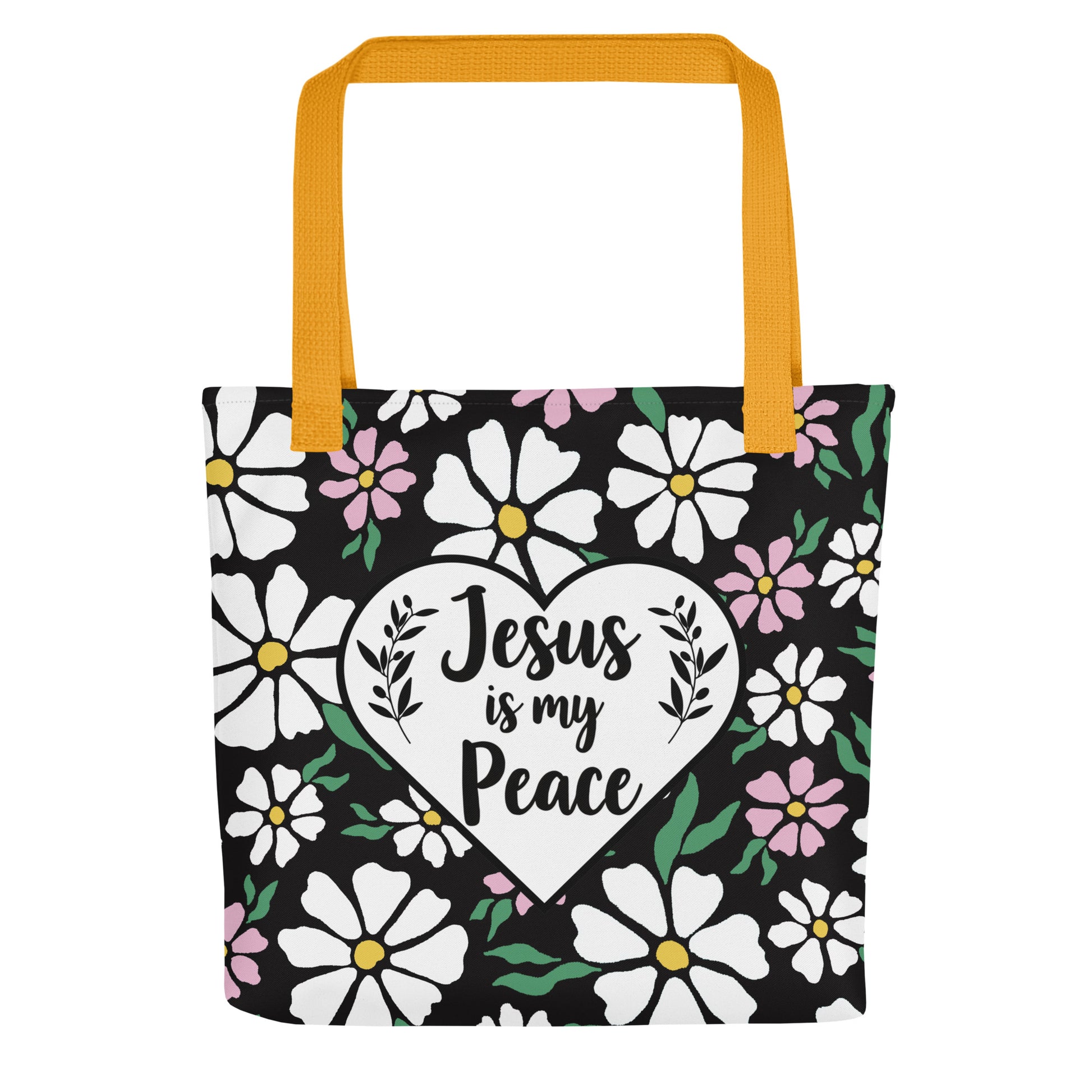 Front view of a black floral tote bag with mustard yellow straps featuring a white heart graphic that reads “Jesus is my Peace.”