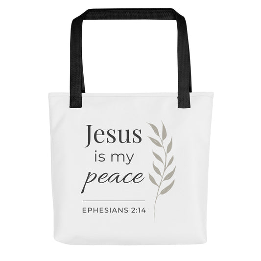 Front view of a white tote bag with black handles featuring “Jesus is my peace,” “Ephesians 2:14,” and a leaf design in dark gray.