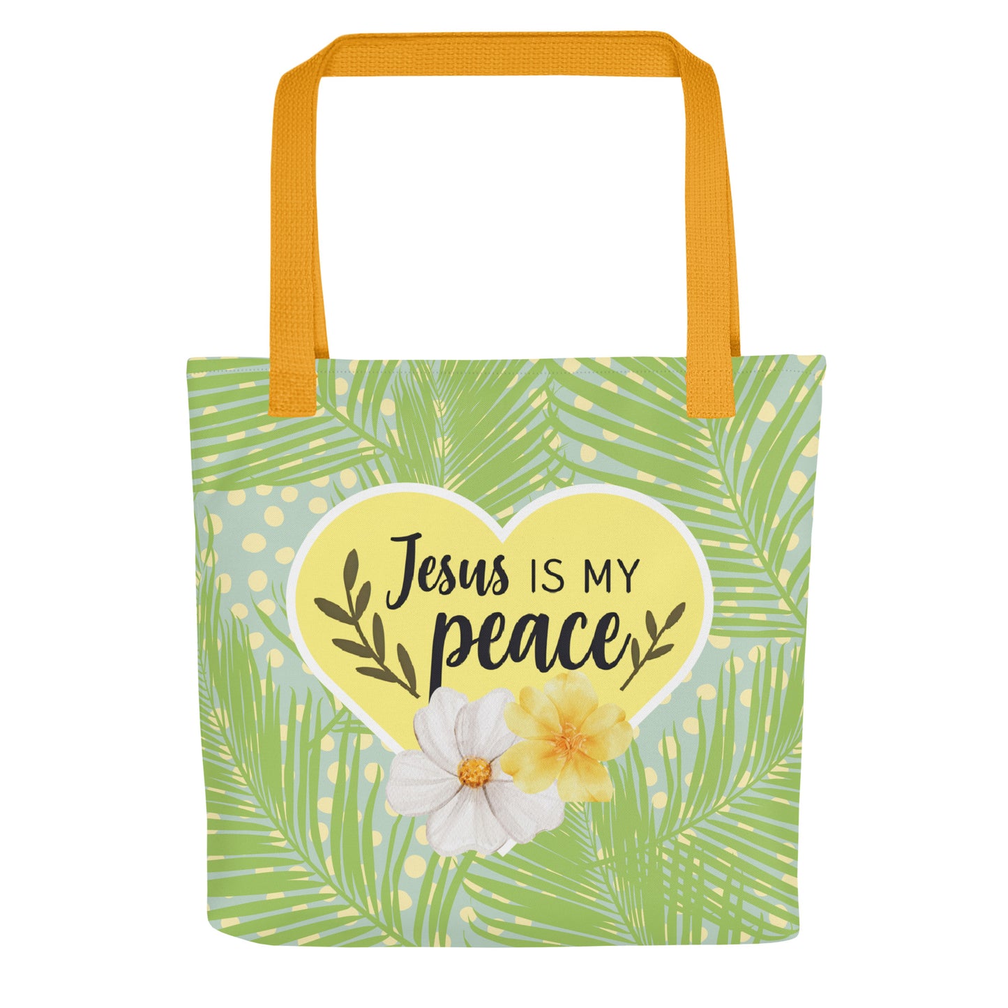 Front view of tote bag with mustard-yellow handles, green palm-leaf print and polka dots, and a yellow heart reading “Jesus is my peace” with two flowers.