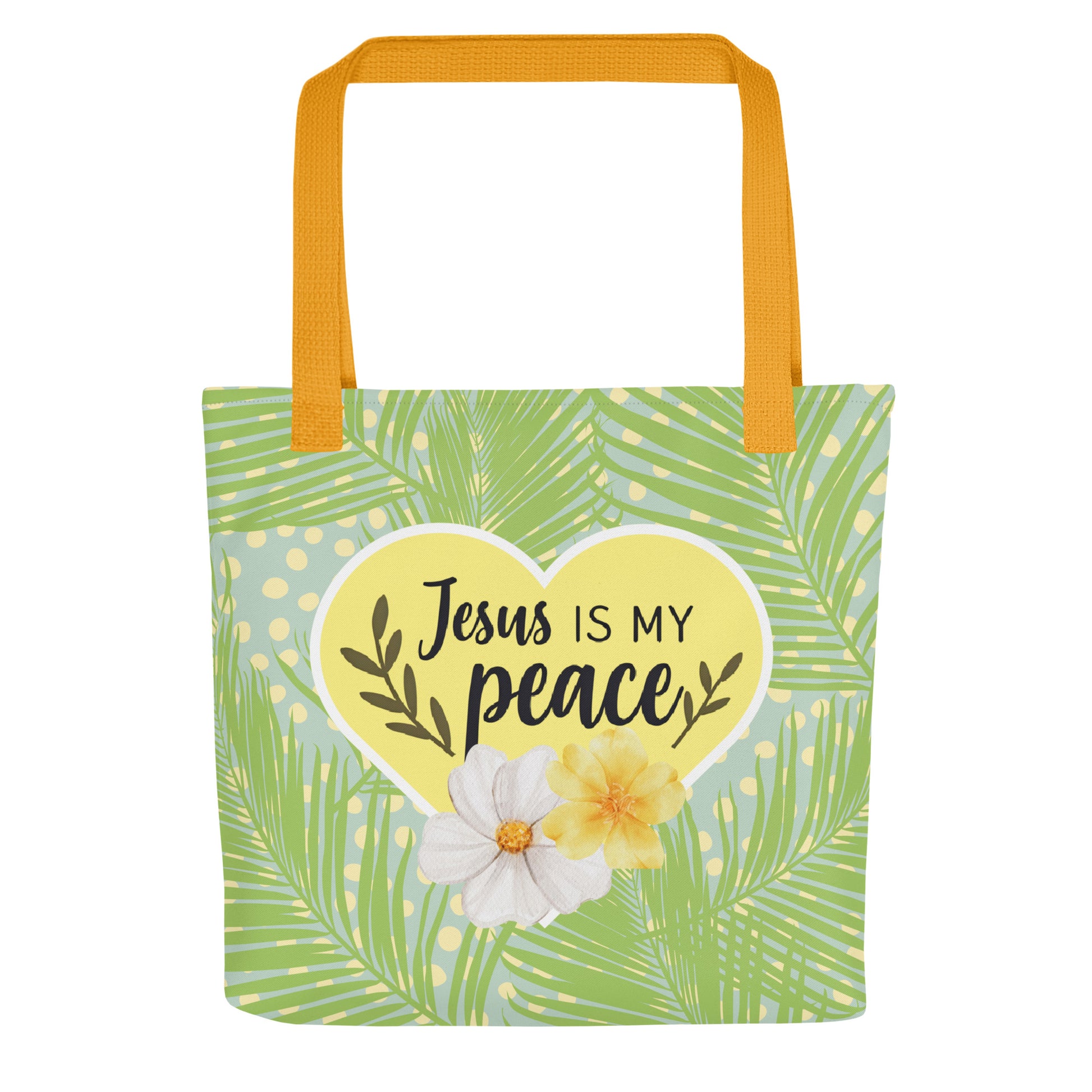 Front view of tote bag with mustard-yellow handles, green palm-leaf print and polka dots, and a yellow heart reading “Jesus is my peace” with two flowers.