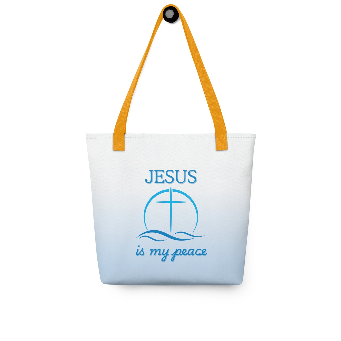 Tote bag hanging on a hook, featuring yellow handles, a light blue wave print, and “JESUS is my peace” with cross design.