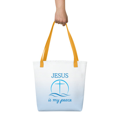 Close carry shot of the tote held by the yellow handles, showing the blue waves and “JESUS is my peace” cross-and-waves artwork.