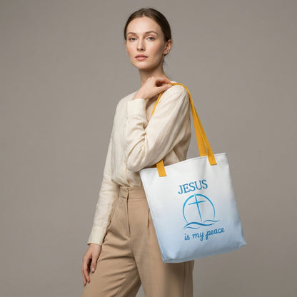 Lifestyle photo of a person carrying the white tote with yellow handles, blue wave pattern, and “JESUS is my peace” cross graphic.