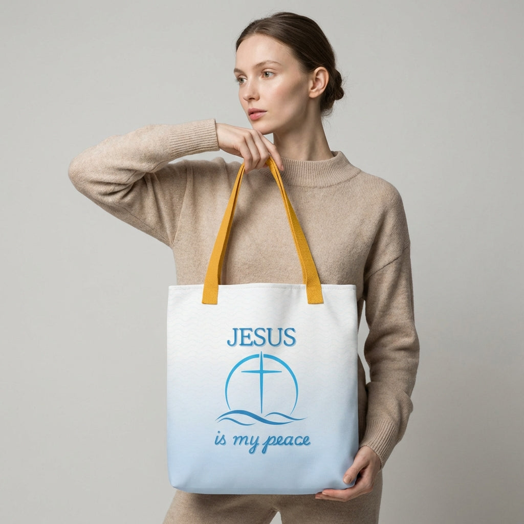 Lifestyle photo of a person carrying the white tote with yellow handles, blue wave pattern, and “JESUS is my peace” cross graphic.