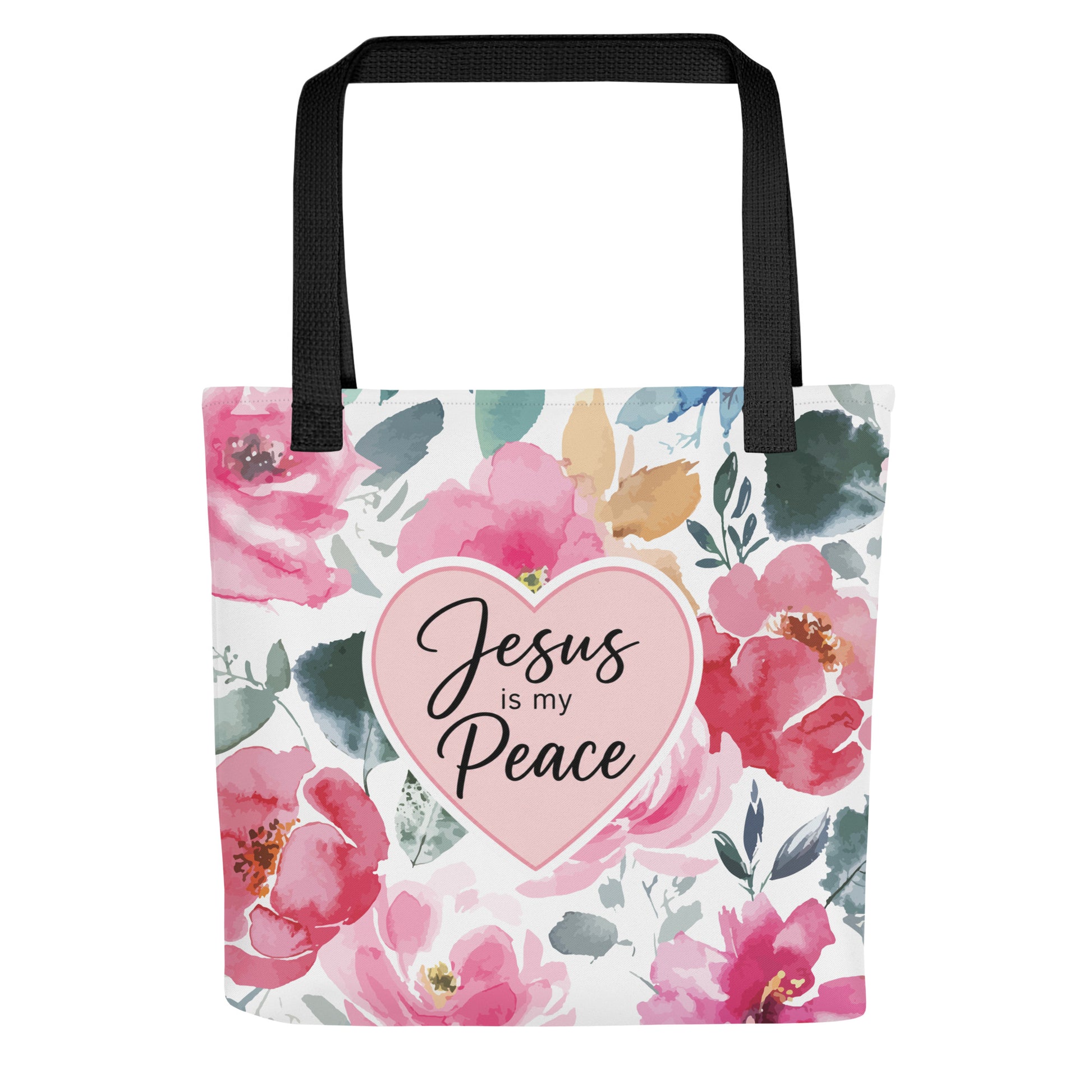 Front view of a floral Christian tote bag with black handles, pink watercolor flowers, and a heart design that says “Jesus is my Peace.”