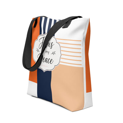 Angled view of a Christian tote bag featuring black straps, modern geometric color blocks, navy stripes, and a centered “Jesus is my Peace” design.