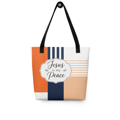 Christian tote bag hanging on a hook, featuring black straps, orange and navy color blocks, and a “Jesus is my Peace” design.