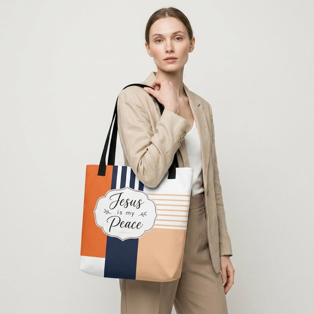 Model carrying a modern Christian tote bag with black handles, geometric color-block artwork, and “Jesus is my Peace” lettering.