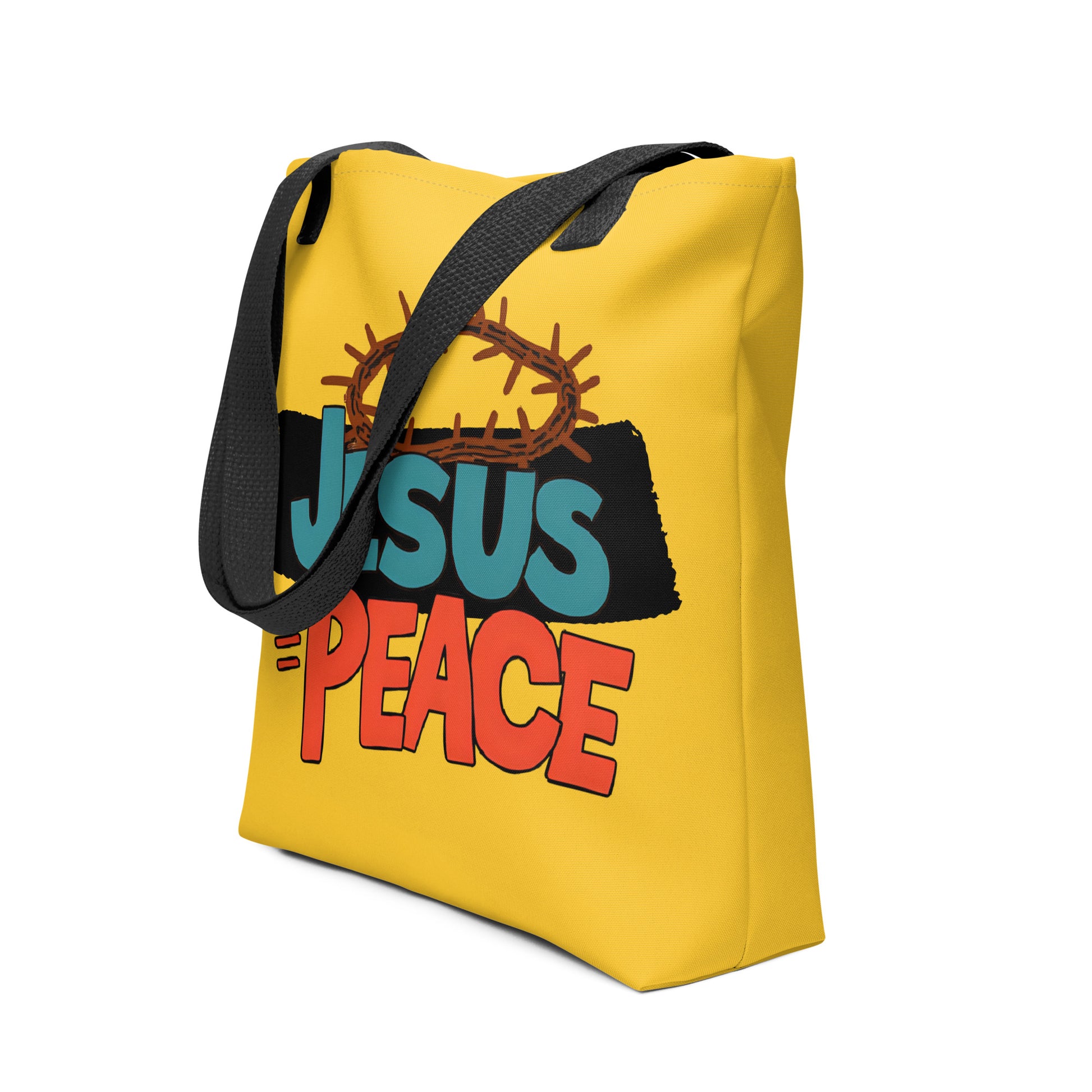 Angled view of yellow tote bag with black handles and “JESUS = PEACE” graphic with a crown of thorns.