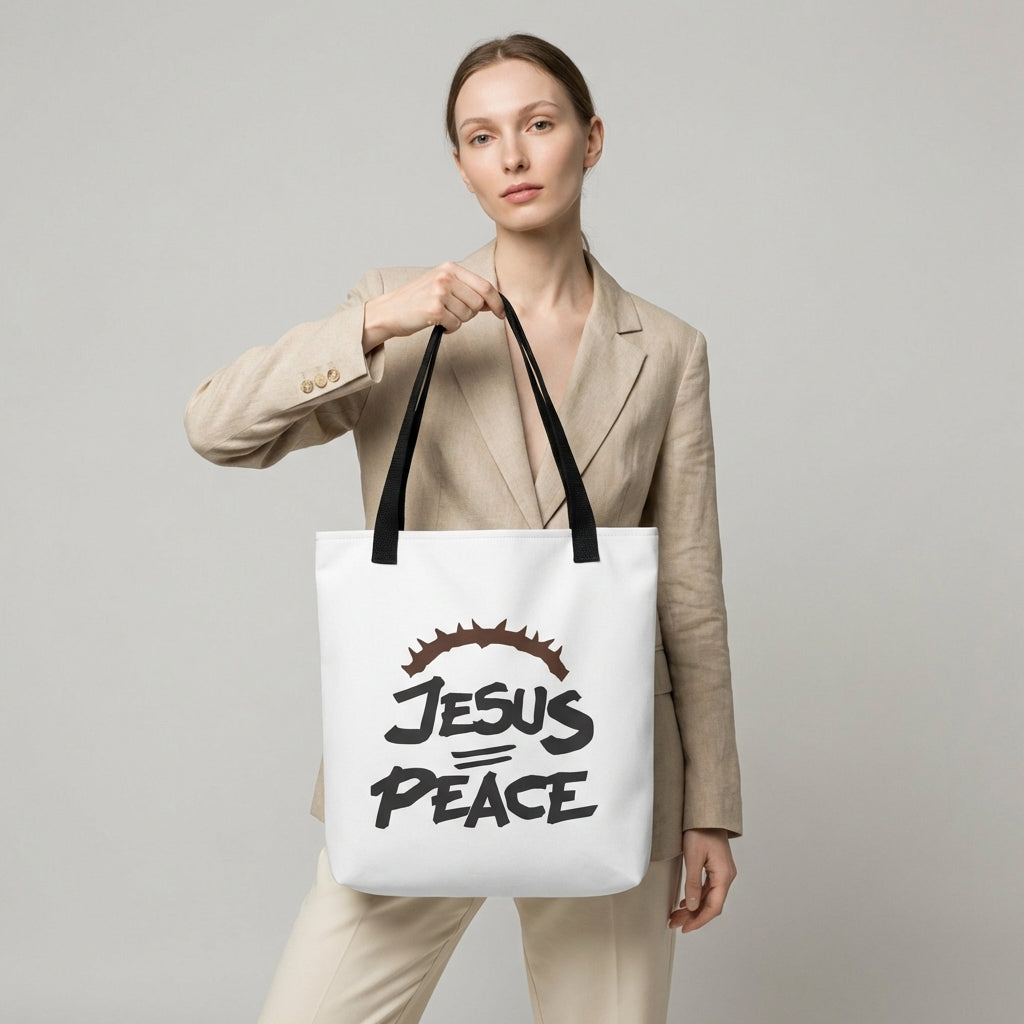 Model carrying a white tote with black handles featuring the “JESUS PEACE” design and crown of thorns graphic.
