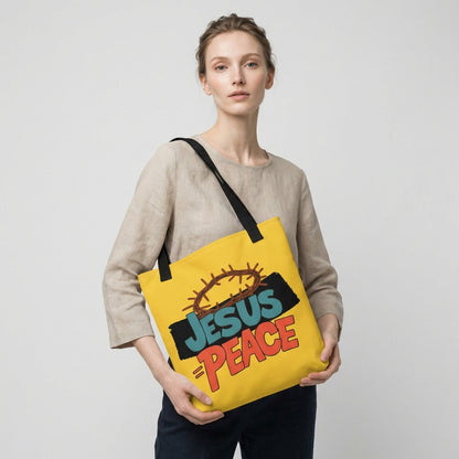 Lifestyle photo of a person carrying the yellow tote bag with black straps and “JESUS = PEACE” graphic with a crown of thorns.