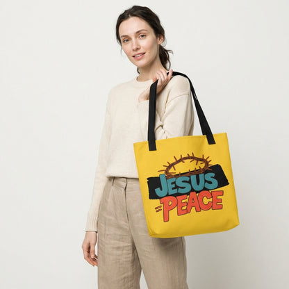 Lifestyle photo of a person carrying the yellow tote bag with black straps and “JESUS = PEACE” graphic with a crown of thorns.