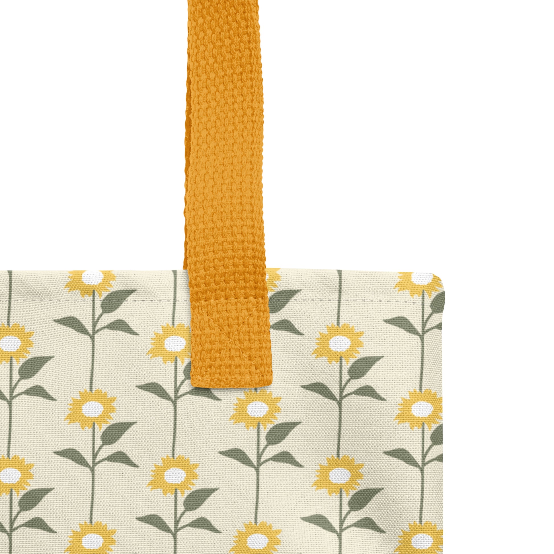 Close-up of a Christian tote bag showing the yellow woven handle, fabric texture, and sunflower pattern with green stems.