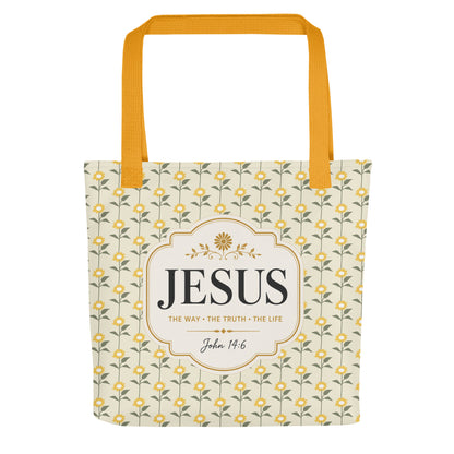 Front view of a Christian tote bag with yellow handles, a floral sunflower pattern, and a “Jesus, The Way, The Truth, The Life, John 14:6” design.