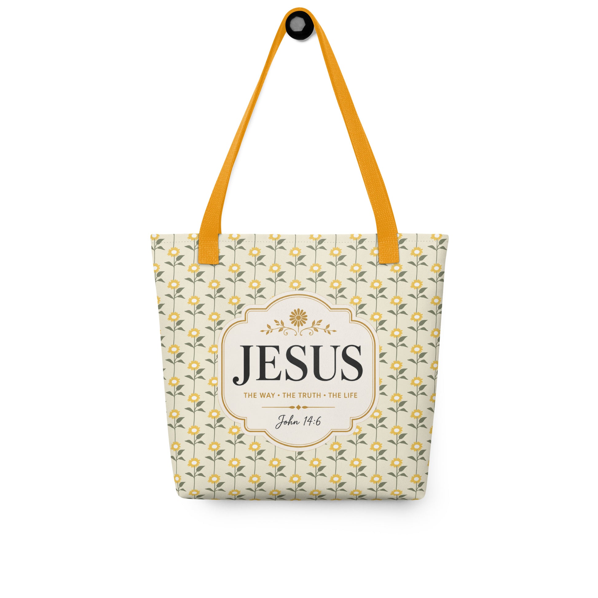Christian tote bag hanging on a hook, featuring yellow straps, a sunflower print, and a faith-based John 14:6 design.
