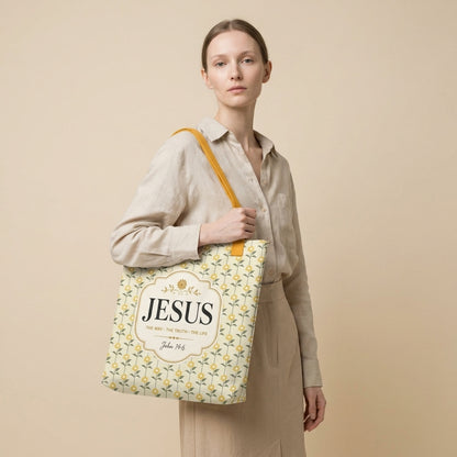 Model carrying a Christian tote bag with yellow handles, a sunflower pattern, and “Jesus, The Way, The Truth, The Life” text.