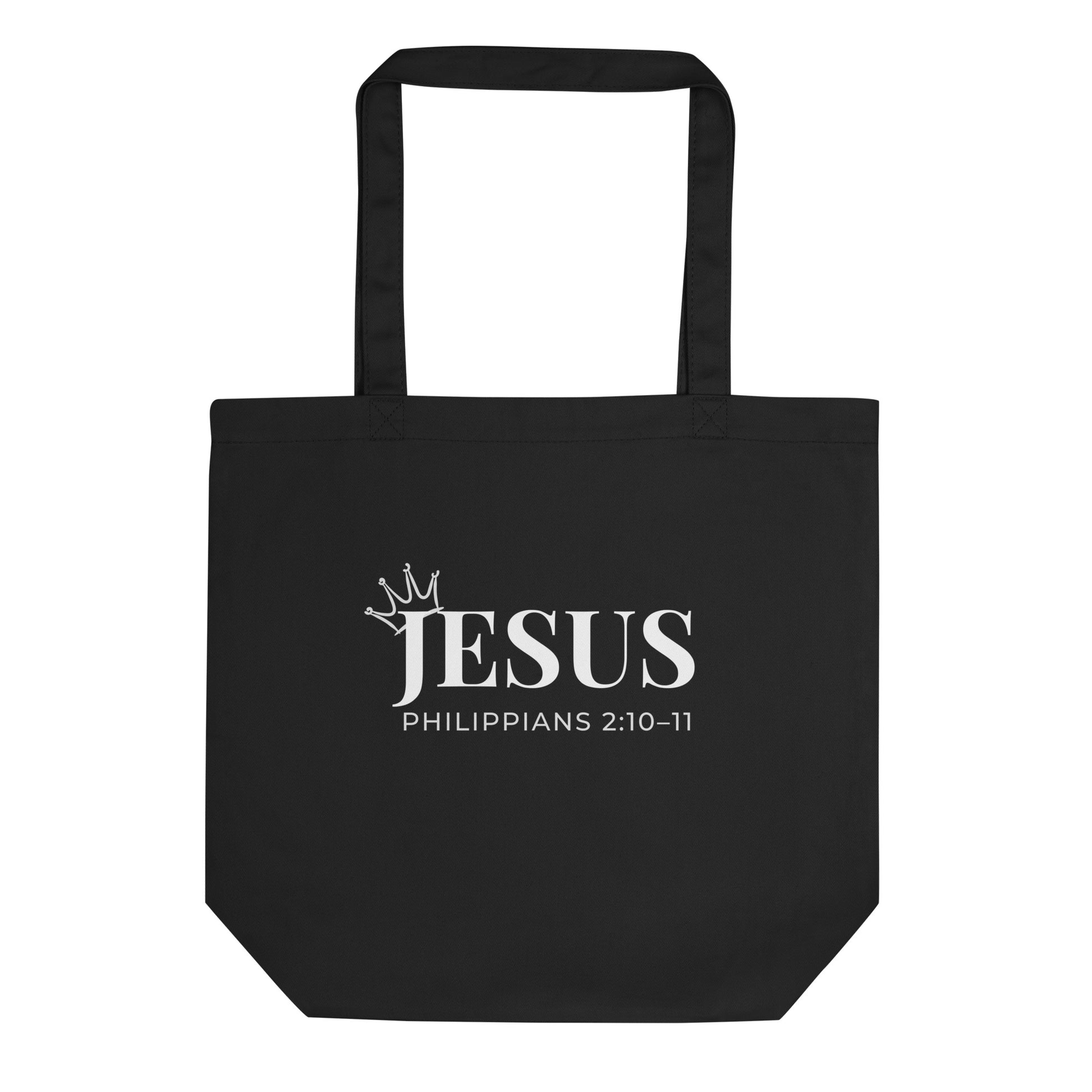 Black cotton tote bag with “JESUS” in white text, a small crown accent, and “Philippians 2:10–11” underneath.