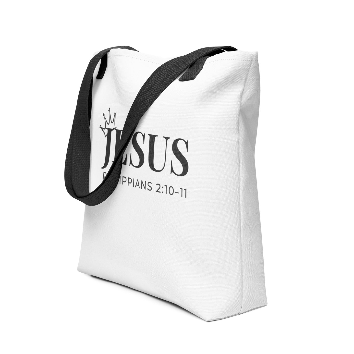 White Christian tote shown at an angle with bold “JESUS” lettering, crown icon, and Philippians 2:10–11.