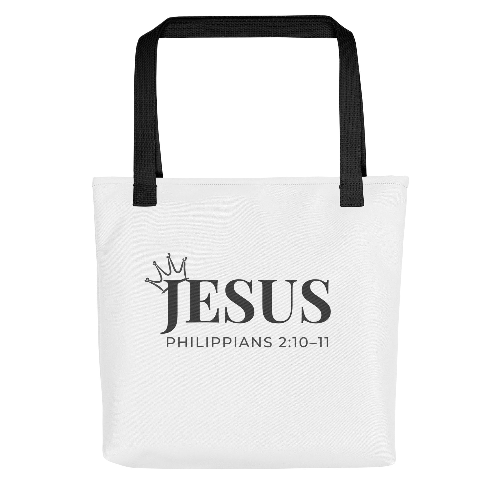 White tote bag with black handles featuring “JESUS,” a crown graphic, and “Philippians 2:10–11” in black text.