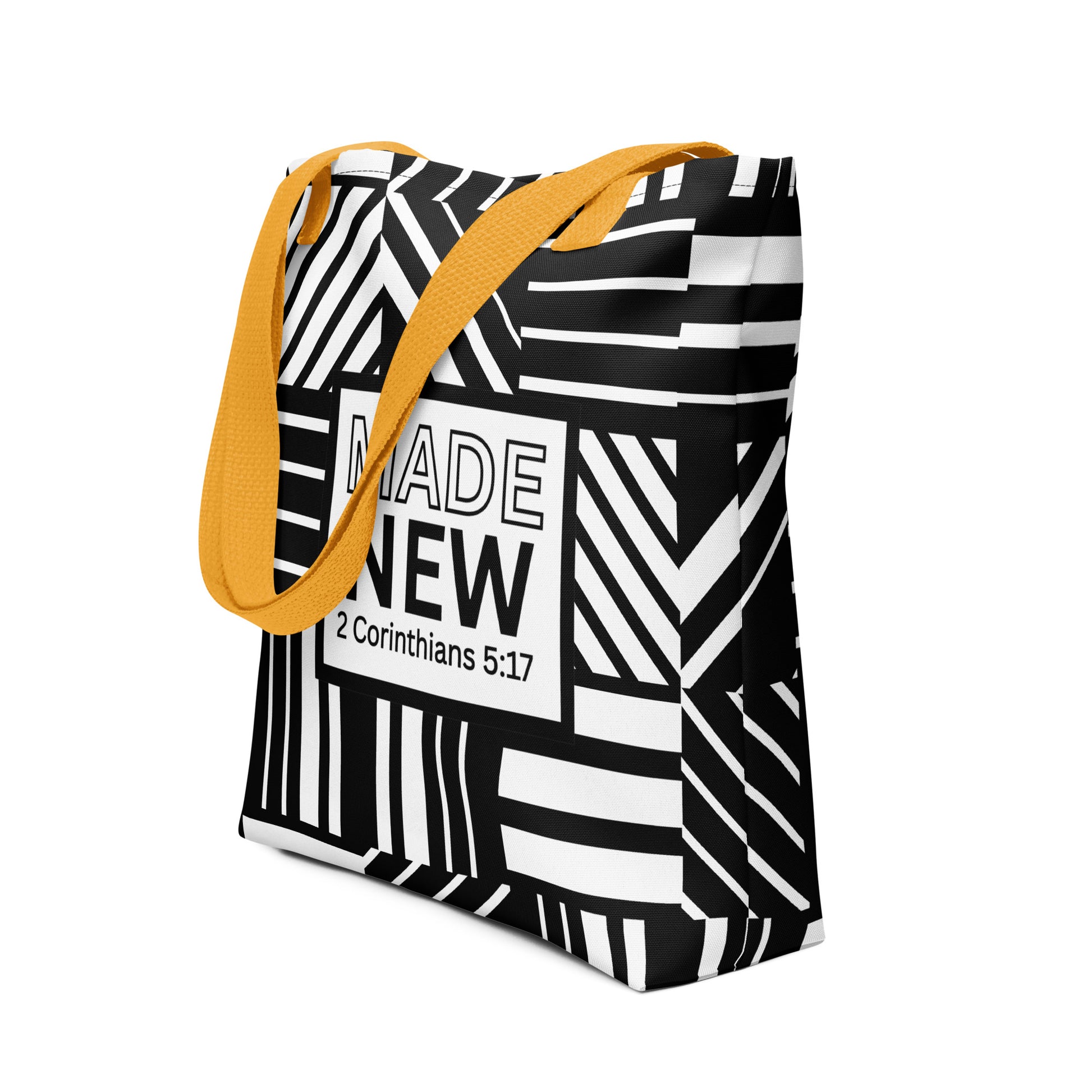 Angled view of the patterned tote with yellow straps, showing the “MADE NEW — 2 Corinthians 5:17” center graphic.