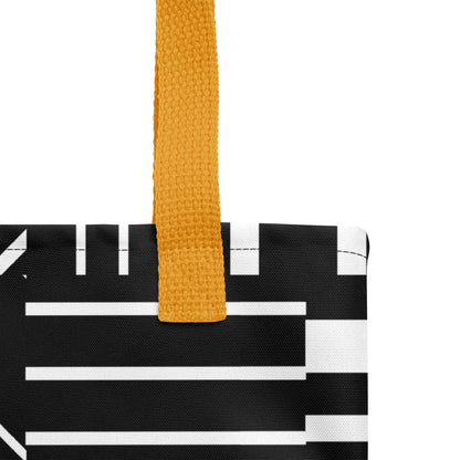Close-up of the black-and-white striped tote fabric and mustard yellow strap, highlighting the stitching, textured canvas, and bold geometric pattern.