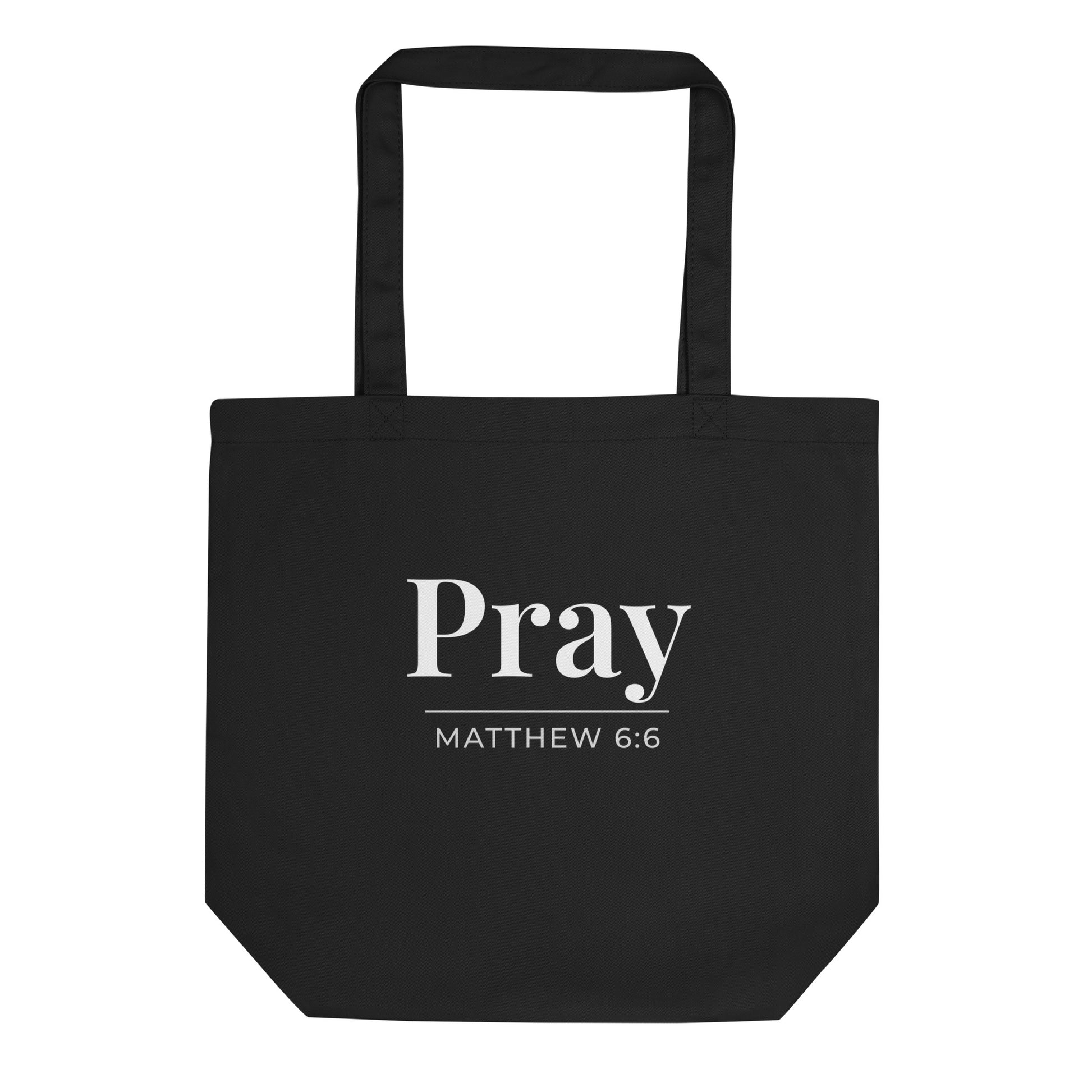 Black cotton tote bag with “Pray” in white text and “Matthew 6:6” printed underneath.