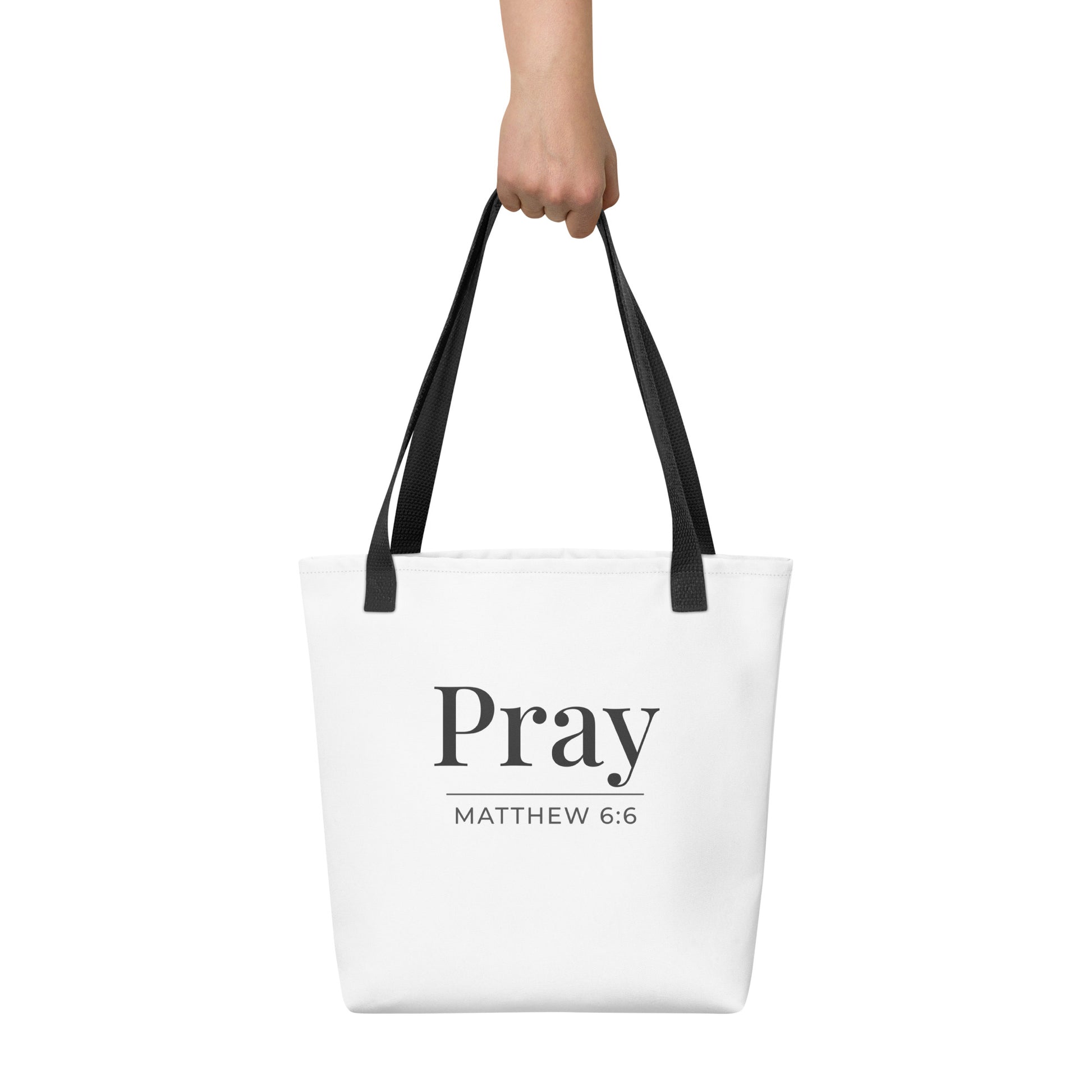 White tote bag held in hand with dark gray “Pray” text and “Matthew 6:6” beneath.