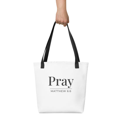 White tote bag held in hand with dark gray “Pray” text and “Matthew 6:6” beneath.