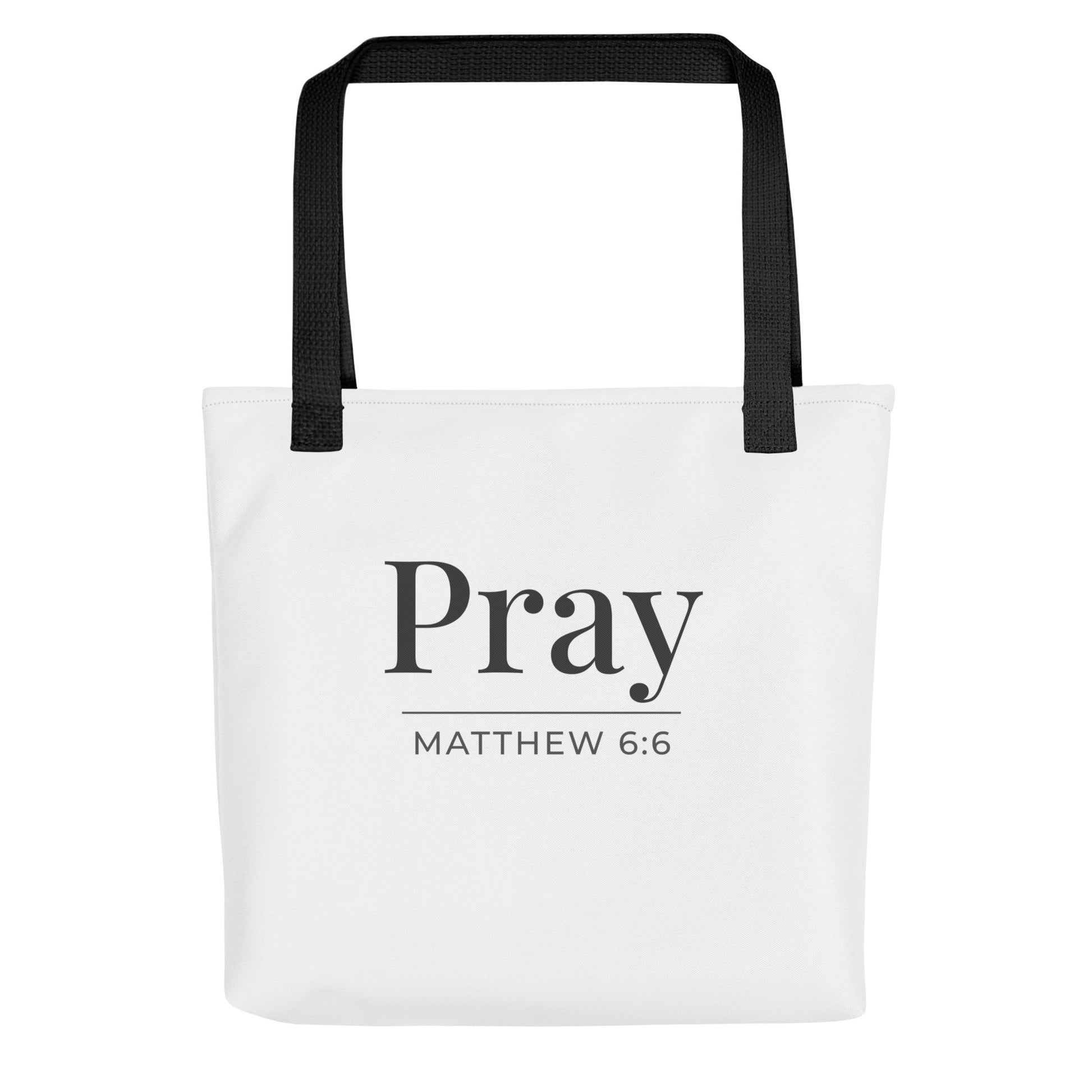 White tote bag with black handles featuring “Pray” and “Matthew 6:6” in dark gray text.