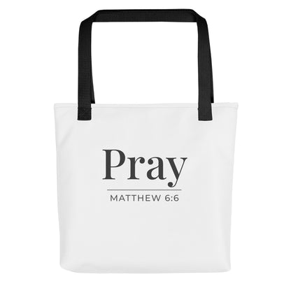 White tote bag with black handles featuring “Pray” and “Matthew 6:6” in dark gray text.